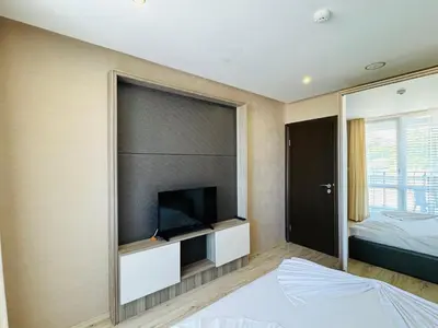a bedroom with a flat screen tv on a wall at PARADISO B 306 Sea View Apartment Nessebar in Nesebar