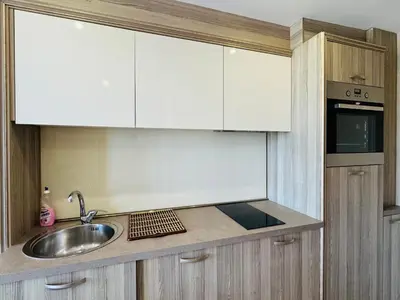 a kitchen with a sink and white cabinets at PARADISO B 306 Sea View Apartment Nessebar in Nesebar