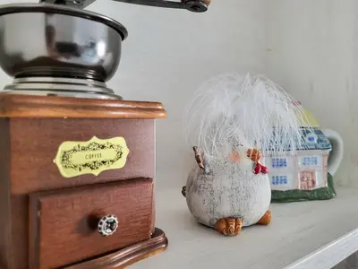 a figurine of a chicken sitting on a counter next to a blender at Уютная квартира рядом с центром Бургаса in Burgas City