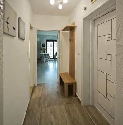 a hallway with a door and a wooden bench at Уютная квартира рядом с центром Бургаса in Burgas City