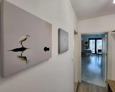 a painting of a bird on a wall in a hallway at Уютная квартира рядом с центром Бургаса in Burgas City