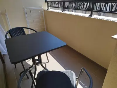 a table and chairs in a room with a balcony at BoriSun with Free Parking space in Burgas City