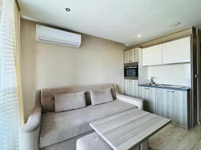 a small living room with a couch and a table at PARADISO B 411 Large SEA VIEW Studio Nessebar in Nesebar