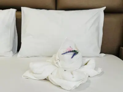 a pile of towels sitting on a bed at PARADISO B 411 Large SEA VIEW Studio Nessebar in Nesebar