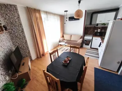 a living room with a black table and chairs at Apartment 15 Sea Grace in Sunny Beach