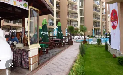 a patio at a hotel with tables and chairs at Apartment 15 Sea Grace in Sunny Beach