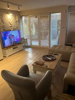 a living room with a couch and a tv at Villa Maria in Sveti Vlas