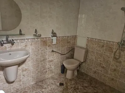 a bathroom with a toilet and a sink at Стая за двама в град Бургас in Burgas City