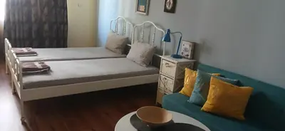 a small room with a bed and a couch at Стая за двама в град Бургас in Burgas City