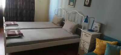 a bedroom with a bed with a white frame at Стая за двама в град Бургас in Burgas City