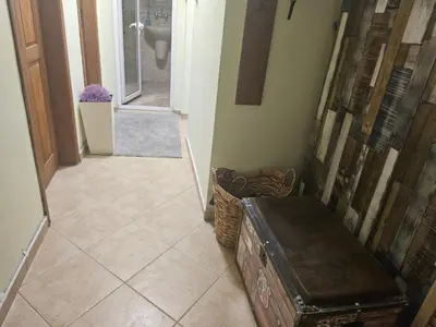 a hallway with aoyer with a toilet and a trunk at Стая за двама в град Бургас in Burgas City