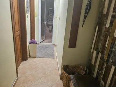 a hallway of a bathroom with a sink and a toilet at Стая за двама в град Бургас in Burgas City