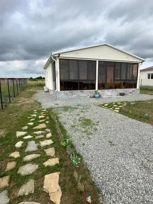 a house with a stone walkway in front of it at Морски Бриз in Lozenets