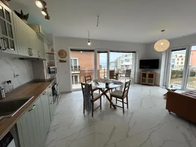 a kitchen and dining room with a table and chairs at On the beach 7 in Sozopol