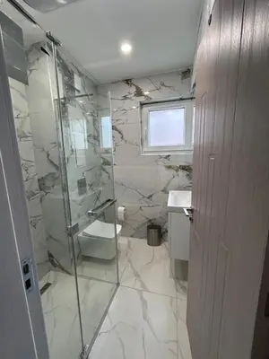 a bathroom with a shower and a toilet and a sink at On the beach 7 in Sozopol