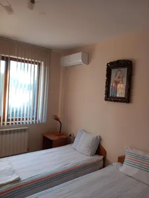 a bedroom with two beds and a picture on the wall at Affordable Rooms with BBQ 5 min drive from beach Villa Lusi in Varna City