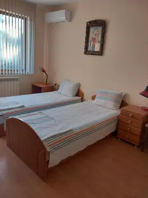 a bedroom with two beds and a picture on the wall at Affordable Rooms with BBQ 5 min drive from beach Villa Lusi in Varna City