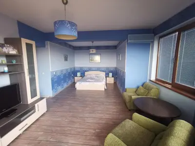 a bedroom with a bed and a couch and a tv at Affordable Rooms with BBQ 5 min drive from beach Villa Lusi in Varna City