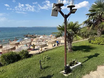 a street light in the grass next to a beach at Etara 4 Sweti Wlas Apart Complex in Sveti Vlas