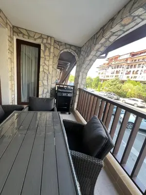 a wooden table and chairs on a balcony at Etara 4 Sweti Wlas Apart Complex in Sveti Vlas