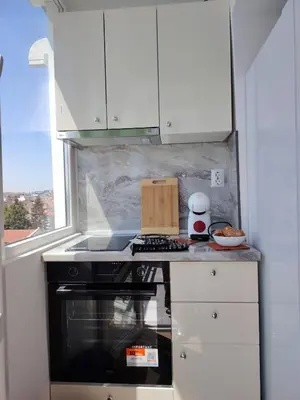 a kitchen with a stove top oven next to a window at Level 5 in Burgas City