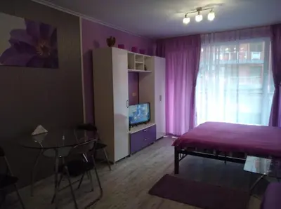 a bedroom with a bed and a table and a window at Parus 4 Studio in Pomorie