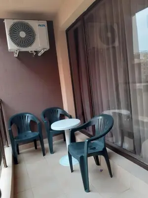 a room with two chairs and a table and a window at Parus 4 Studio in Pomorie