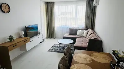 a living room with a couch and a tv at JADORE DUNE Apartment 10 Sunny Beach in Sunny Beach
