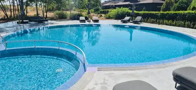 a large pool with blue water in a yard at JADORE DUNE Apartment 10 Sunny Beach in Sunny Beach