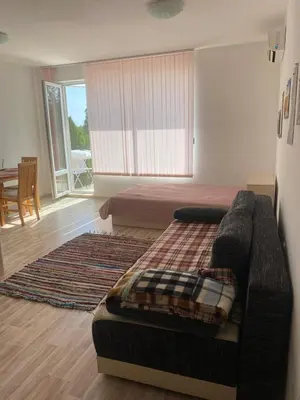 a bedroom with a bed and a couch in a room at Sunny Byala in Byala