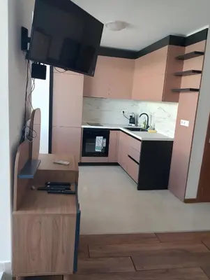 a kitchen with a tv and a table with a counter at Sea Studio 22 in Nesebar