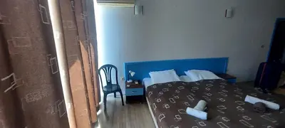 a bedroom with a blue bed and a chair at Jolka in Sunny Beach