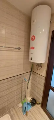 a bathroom with a toilet and a broom and a sink at Jolka in Sunny Beach