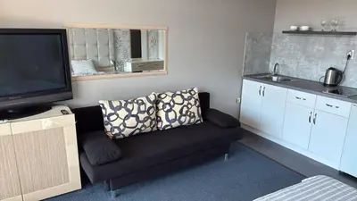 a living room with a couch and a flat screen tv at Jolka in Sunny Beach