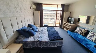 a bedroom with a large bed and a couch at Jolka in Sunny Beach
