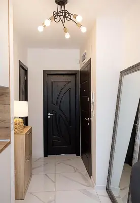 a black door in a room with a mirror at BuenaVista I Modern Comfort near Varna City Center by Flat Mаnаger in Varna City