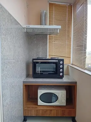 a microwave sitting on top of a counter at Top Floor Two Bedroom Apartment in Central Burgas in Burgas City