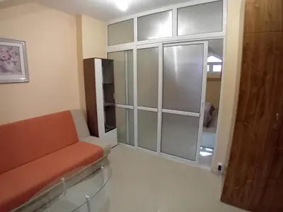 a living room with a couch and a sliding glass door at Top Floor Two Bedroom Apartment in Central Burgas in Burgas City