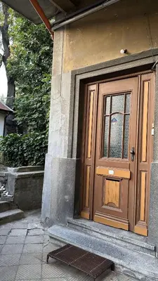 a wooden door on the side of a house at Top Floor Two Bedroom Apartment in Central Burgas in Burgas City