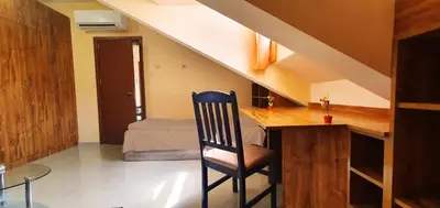 a room with a desk with a chair and a bed at Top Floor Two Bedroom Apartment in Central Burgas in Burgas City