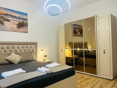 a bedroom with a bed with towels on it at Detelina Apartment Bee Happy in Burgas in Burgas City