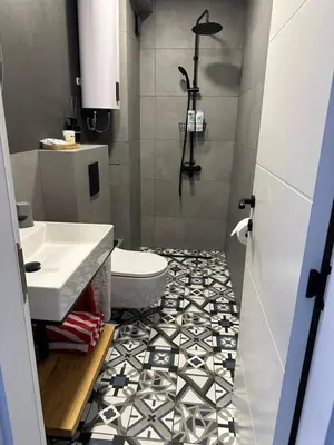a bathroom with a white toilet and a sink at Cozy sea view studios in Sozopol