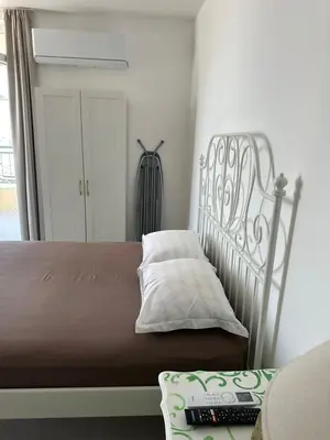 a bed sitting in a room with at Cozy sea view studios in Sozopol