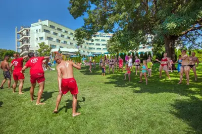 a group of people playing frisbee in a park at Jeravi Club Hotel - All Inclusive in Primorsko