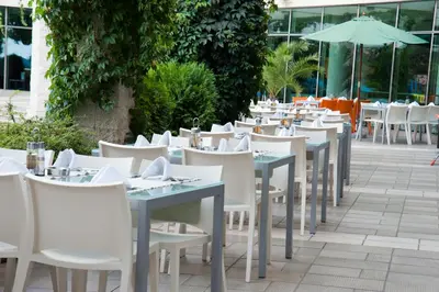a row of tables and chairs at a restaurant at Jeravi Club Hotel - All Inclusive in Primorsko