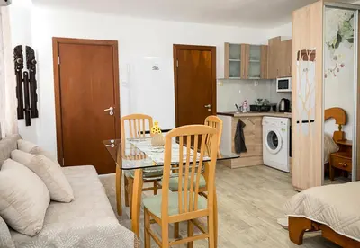 a kitchen and living room with a table and chairs at Central Studios on Maria Luiza Street - Cozy Stay in Varna by Flat Mаnаger in Varna City