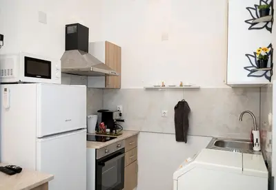 a kitchen with a white refrigerator and a sink at Central Studios on Maria Luiza Street - Cozy Stay in Varna by Flat Mаnаger in Varna City