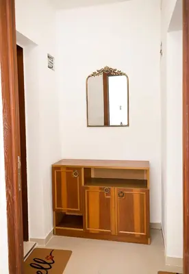 a mirror above a wooden cabinet in a room at Central Studios on Maria Luiza Street - Cozy Stay in Varna by Flat Mаnаger in Varna City