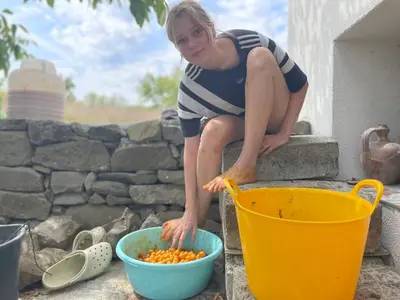 a woman sitting on a step next to a bowl of food at Villa Suhodol