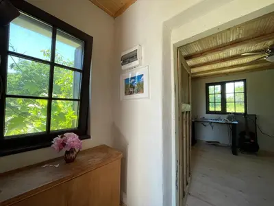 a room with a window and a vase with flowers at Villa Suhodol